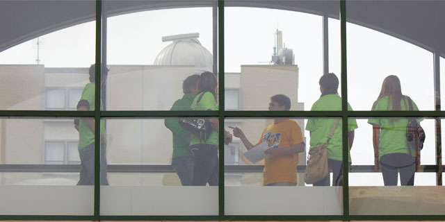 Students and tour guide standing in skywalk