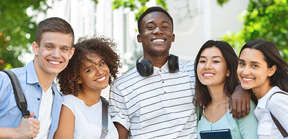Group of students outside smiling at camera