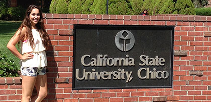 Student standing in front of California State University, Chico sign