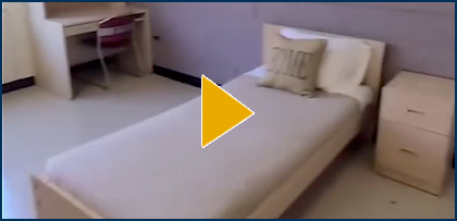 Interior Flora Cowan Standard Room with Video Play Button overlayed