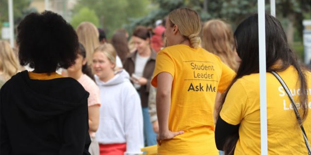 Student Leader standing among crowd of students